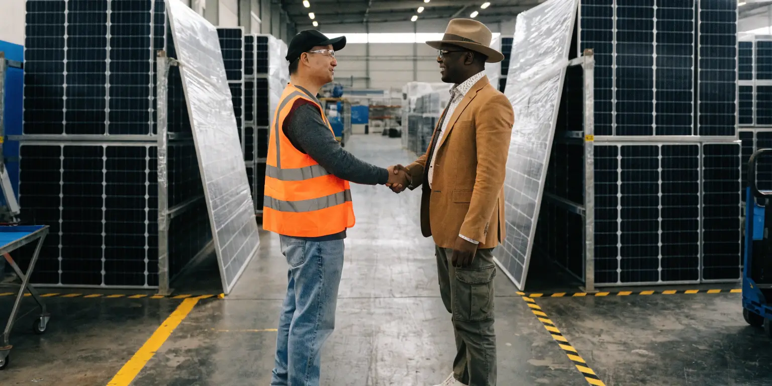 solar panel supplier handshake in factory, international solar trade partnership